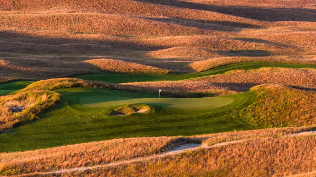 Scenic view of a golf course with rolling hills and a green in Nebraska.
